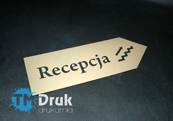 Strzałka kierunkowa mocowana na ścianie, wycięta i wygrawerowana z złotego laminatu grawerskiego